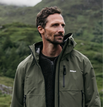 A founder in a green jacket outdoors